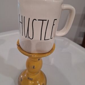 Rae Dunn White Mug with Black 'HUSTLE' Lettering and Yellow Stand